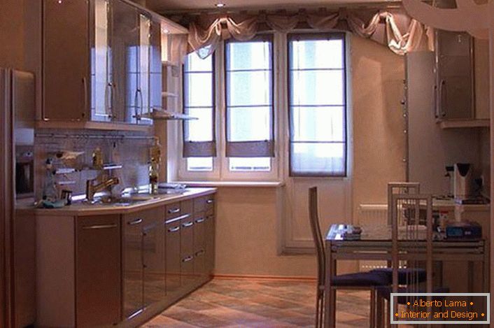 Prostorna kuhinja z visečimi omarami v svetlih bež barvah izgleda privlačna in izvrstna. Namesto shrambe je oblikovalec postavil nišo, kjer je bila za udobje postavljena hladilnik.