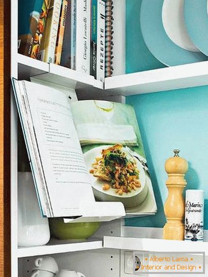 Knjige in pripomočki v majhni kuhinji v turkiznih barvah
