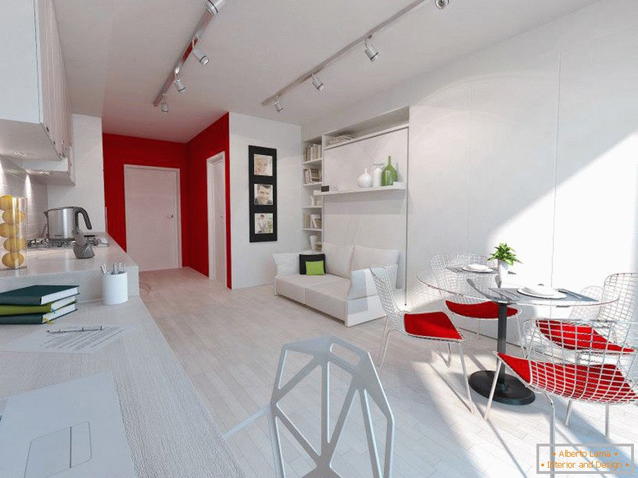 Bela notranjost majhnega apartmaja z rdečimi poudarki